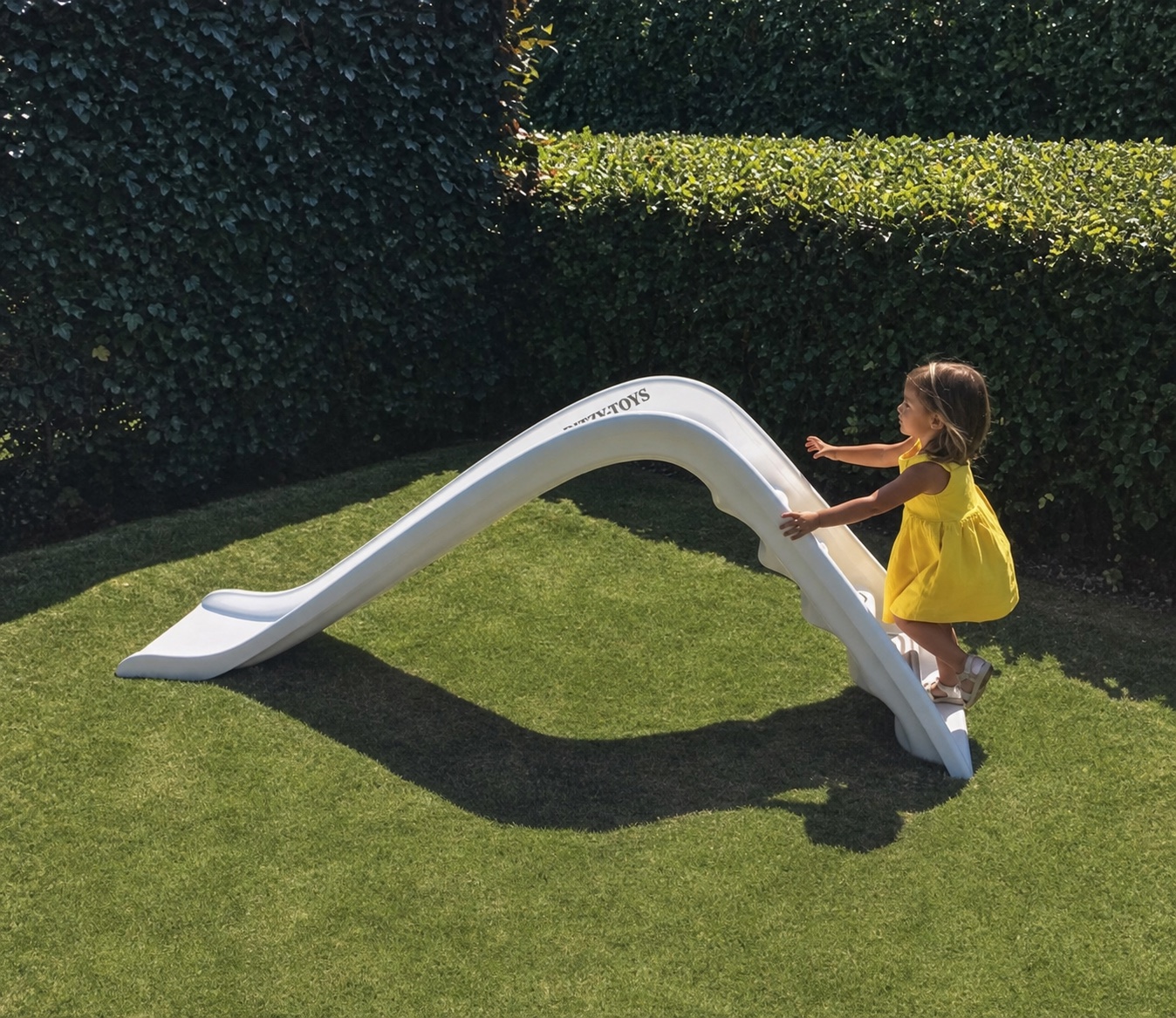 A child climbing the pearl-white Ritzy-Slide in a garden